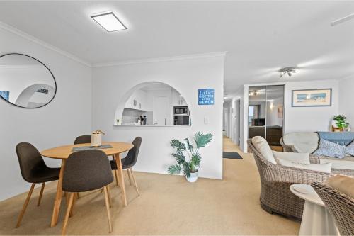 a living room with a table and chairs and a couch at Seaside Holiday Apartments Tugun in Gold Coast