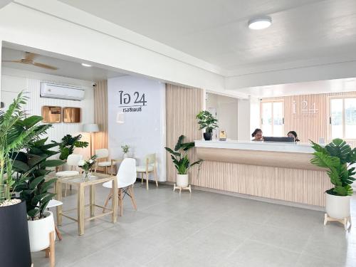 a woman sitting at a counter in a salon with plants at i24 Residence - Amata Phase 10 in Ban Mai (1)