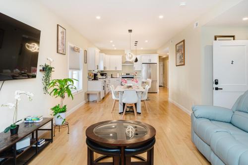 a living room with a blue couch and a table at 60-2 3BR Boston - Modern Apt near Franklin Park in Boston