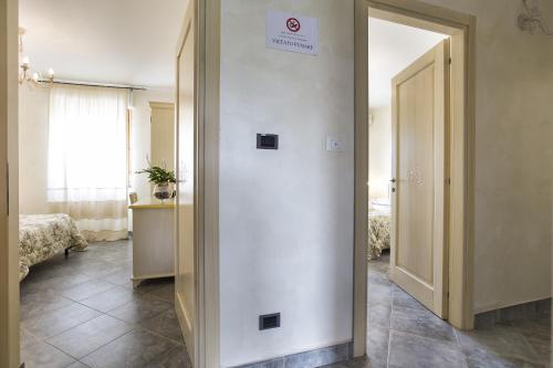 a room with a door with a sign on it at Morpheo Rooms in Alghero