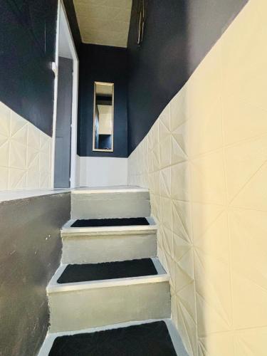 a staircase in a room with black and white tiles at Sereni house jacuzzi in Narbonne