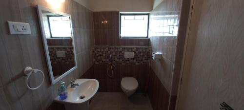 a small bathroom with a sink and a toilet at Shantham Service Apartments, Indumanagar, Coimbatore in Coimbatore