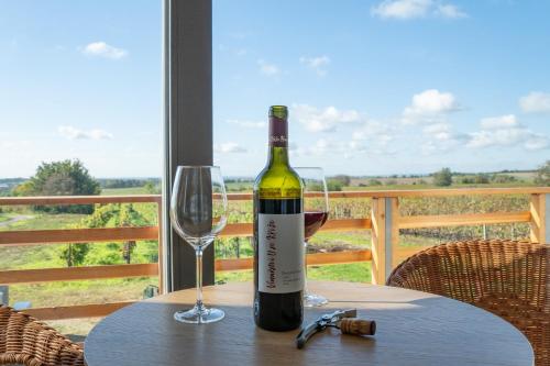 a bottle of wine sitting on a table with a glass at Vinařství U sv. Kříže in Prušánky