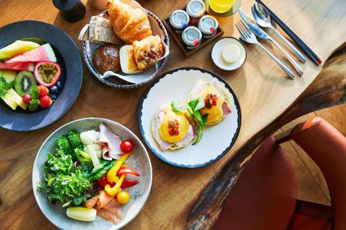 a wooden table with plates of food on it at Andaz Tokyo - A Concept by Hyatt in Tokyo