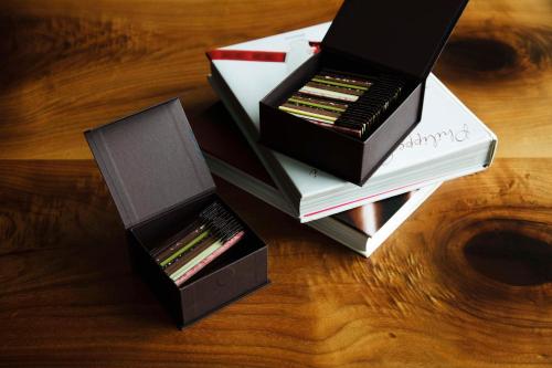 two boxes of books sitting on top of a table at Andaz Tokyo - A Concept by Hyatt in Tokyo