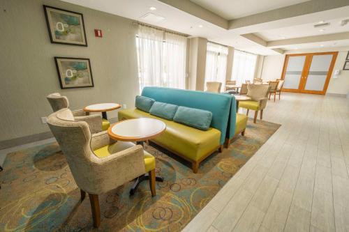 a living room with a couch and chairs and tables at Hampton Inn Jacksonville South/I-95 at JTB in Jacksonville