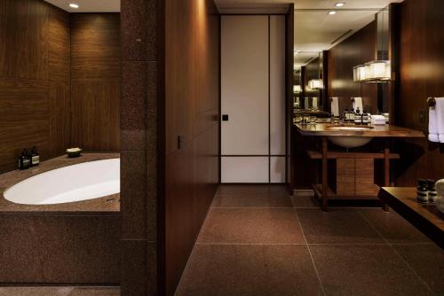 a bathroom with a large tub and a sink at Andaz Tokyo - A Concept by Hyatt in Tokyo