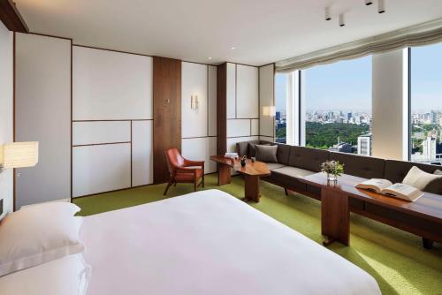 a hotel room with a bed and a couch at Andaz Tokyo - A Concept by Hyatt in Tokyo