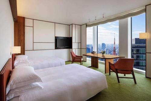 a hotel room with two beds and a table at Andaz Tokyo - A Concept by Hyatt in Tokyo