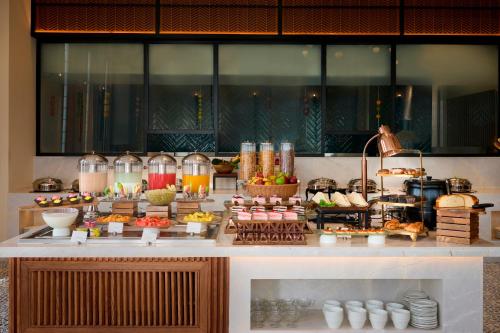 a buffet line with food on a table at Iris Sarovar Portico in Gurgaon
