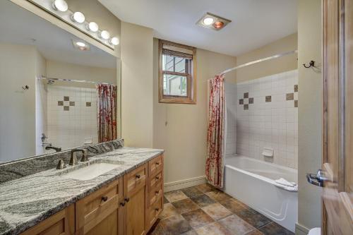 a bathroom with a sink and a tub and a shower at River Run Village by Keystone Resort in Keystone