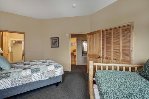 a bedroom with two beds and a closet at River Run Village by Keystone Resort in Keystone
