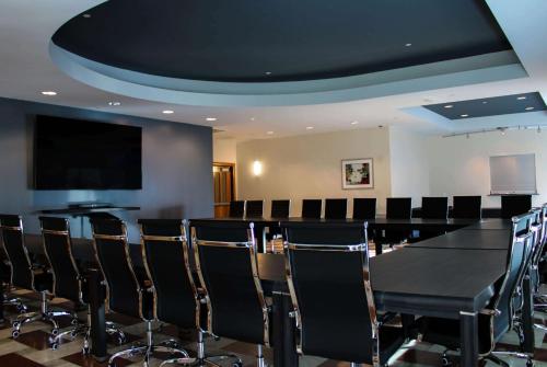 a conference room with a black table and chairs at Broadway Plaza, Trademark Collection by Wyndham in Rochester