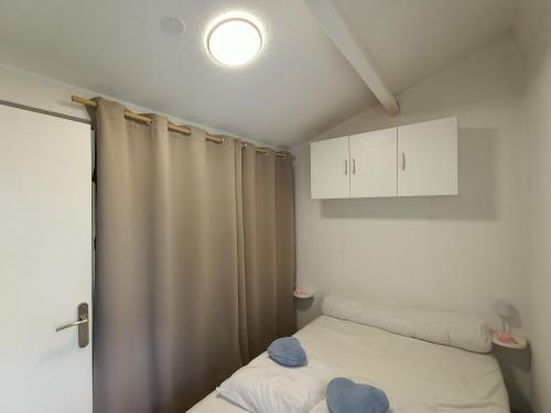 - une petite chambre avec un lit et une lumière dans l'établissement Coquet T3 familial à Cap Coudalère avec parking privatif - FR-1-799-51, au Barcarès