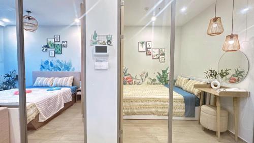 a small bedroom with a bed and a mirror at The Song Luxury Vung Tau - Khang Apartment 1 in Vung Tau