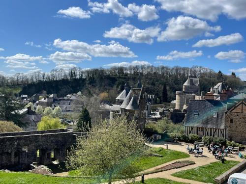 a view of a town with buildings and trees at Le Relais Médiéval in Fougères