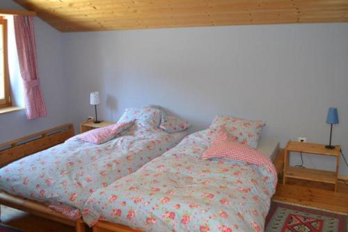 a bedroom with two beds and a wooden ceiling at Ferienhaus Casa Patricia in Brigels