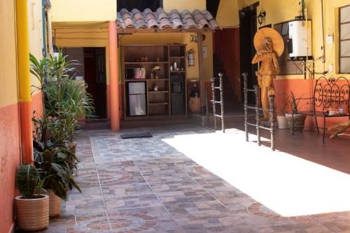 a hallway of a building with plants on the floor at Habitación triple zona centro in Zacatlán