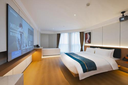 a bedroom with a large bed and a flat screen tv at Ruixin Hotel Near Jiangbei Airport in Chongqing
