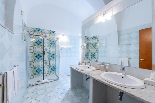 a bathroom with two sinks and a shower at Hotel Fontana in Amalfi