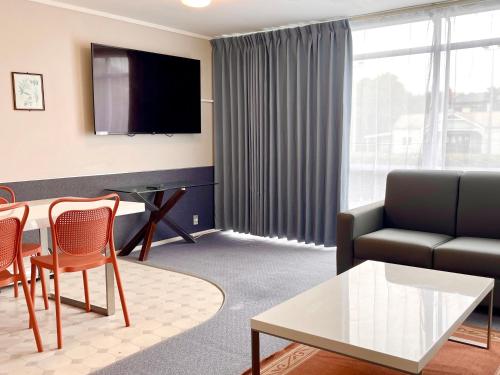 a living room with a couch and a table at Mount Eden Motel in Auckland