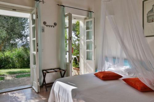 a bedroom with a bed and an open door at Hotel Santo Stefano in Portoferraio