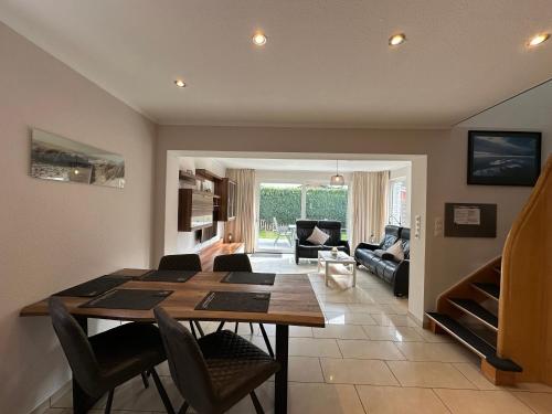 a dining room and living room with a table and chairs at Flipper in Sierksdorf