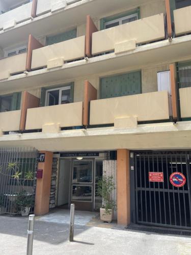 un immeuble de bureaux avec un panneau à l'avant dans l'établissement Joli studio niçois proche mer, à Nice