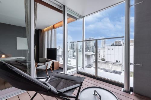 a room with a hammock in front of a large window at Tokyu Stay Osaka Hommachi in Osaka
