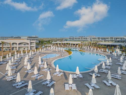 an overhead view of a pool with chairs and umbrellas at Blue Lagoon Queen in Kalyves Poligirou