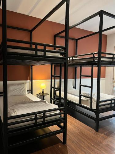 two bunk beds in a room with a lamp at Senai Hill 24 Homestay in Kampong Saleng