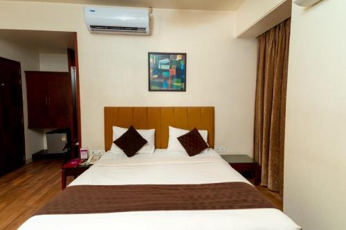 a bedroom with a large bed in a room at Hotel Chaitali - Pure Veg in Kolhapur