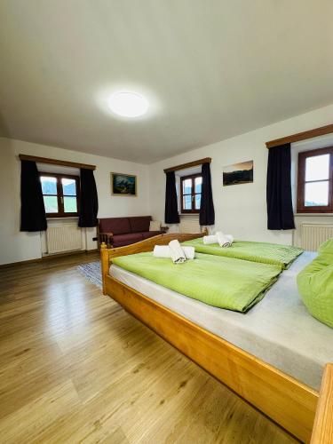 a large bedroom with two beds and a couch at Ferienwohnung Beim Raffner in Ruhpolding