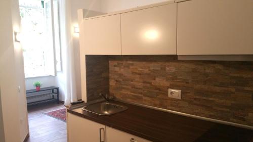 a kitchen with a sink and a counter top at Appartamenti Mergellina in Naples
