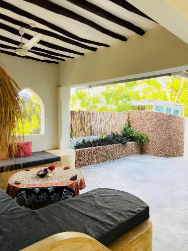 ein Zimmer mit zwei Betten und einem großen Fenster in der Unterkunft Banana Shamba Estate in Lamu