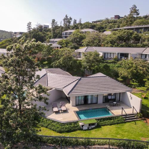 an aerial view of a house with a swimming pool at Courtyard by Marriott Mahabaleshwar in Mahabaleshwar