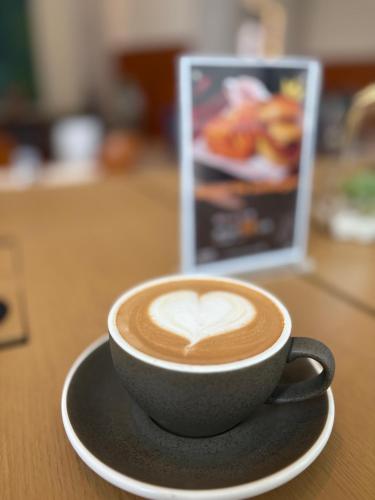 a cup of coffee with a heart on a table at Holiday Inn Shanghai Pudong Kangqiao by IHG - Free shuttle bus to Disney land, Ins Swimming Pool in Shanghai