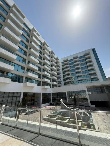 a large building with two tall buildings at Elegant 2BR by Vendome mall in Lusail