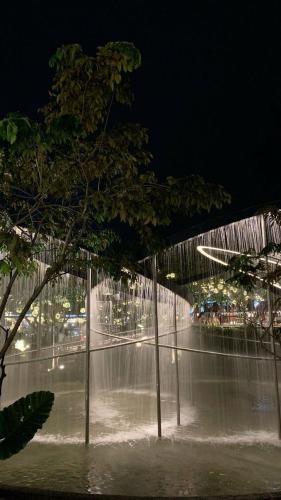 a view of a water fountain at night at R & J Homestay in Naga Cebu in Tina-an