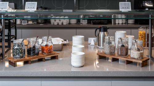 a counter with a bunch of jars of food at Hunguest Hotel Flóra in Eger
