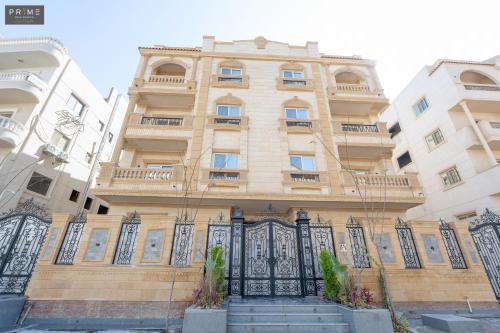 a building with a gate in front of it at Prime Residence Zayed Heights in Sheikh Zayed