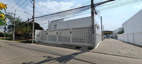 a white fence on the side of a street at Modern Villa with Big Jacuzzi Lets Relax at City LRP4 in Nong Prue