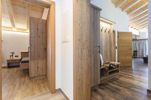 a room with wooden doors and wooden floors at Ferienwohnungen Recherhof in Hochfilzen