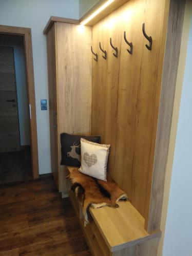 a dog laying on a bench in a room at Ferienwohnungen Recherhof in Hochfilzen