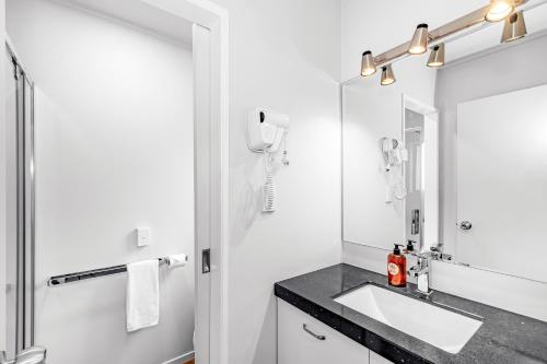 a bathroom with a sink and a mirror at Auckland Airport Motel in Auckland