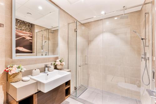 a bathroom with a sink and a shower at Luxury 2BR in Sobha Hartland in Dubai