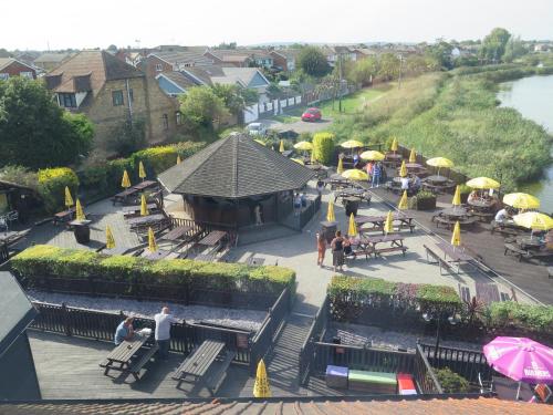 an overhead view of a restaurant with tables and umbrellas at Oyster Fleet Hotel in Canvey Island