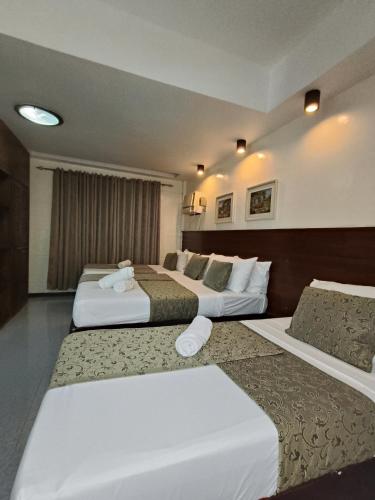 a hotel room with two beds in a room at Delle Suites in General Santos