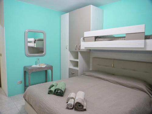 a bedroom with a bed with a pair of shoes on it at Casa Zuliani - bilocale in Costa Azzurra in Grado