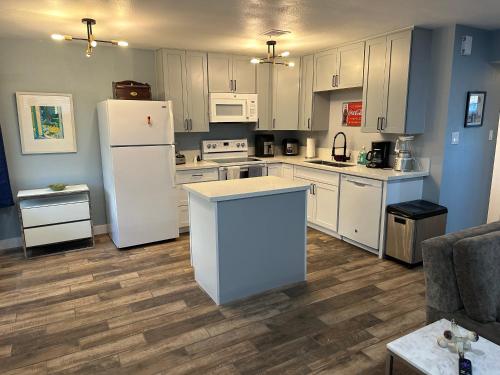 a kitchen with white cabinets and a white refrigerator at Casada in Las Vegas